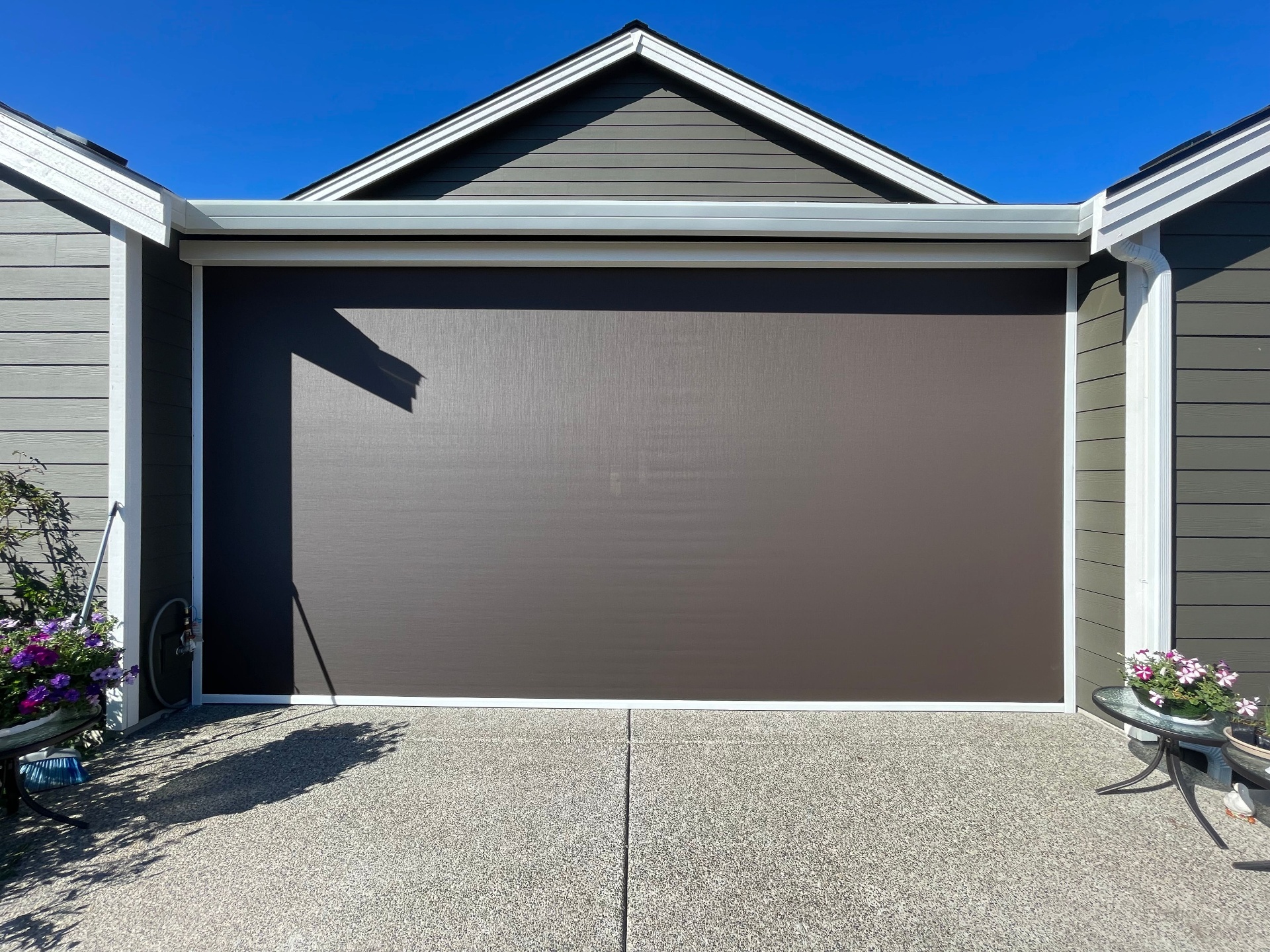 Mirage H4500 motorized retractable screen installed on a garage door